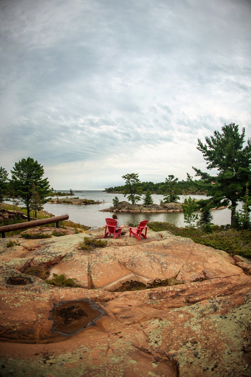 Two red chairs on a rock in natural park