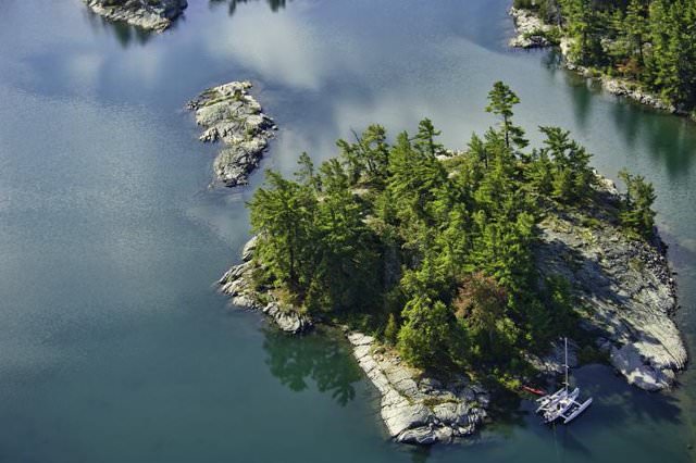 Luftaufnahme einer kleinen felsigen Insel in einem See