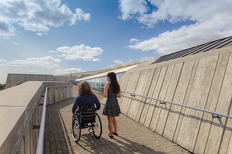 Two people ascend the ramp to the rooftop of the Canadian War Museum.