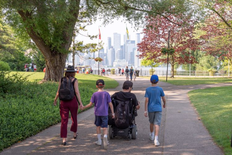 A family walks along a paved path on Centre Island.