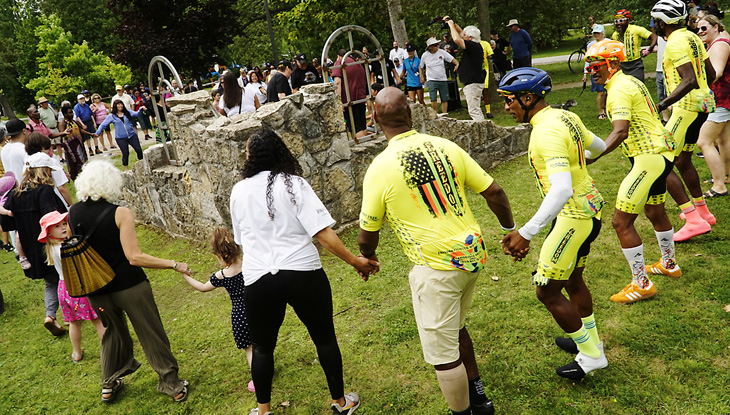 A group of people holding hands in a circle