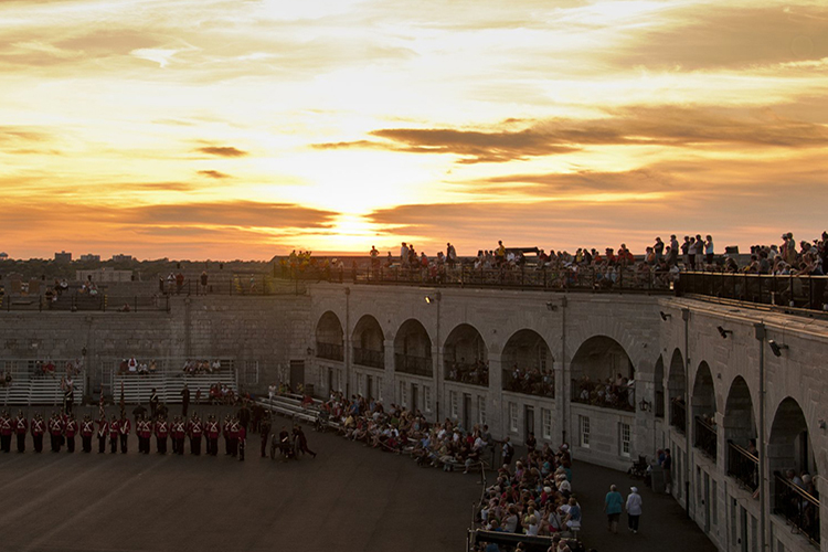 Crowds gather to watch military ceremonies at sunset at Fort Henry.