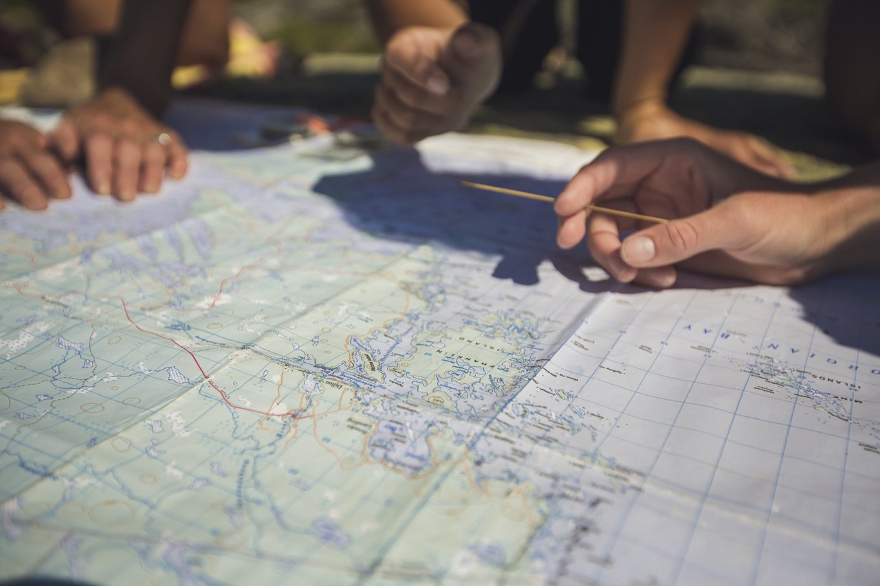 Several hands on a map