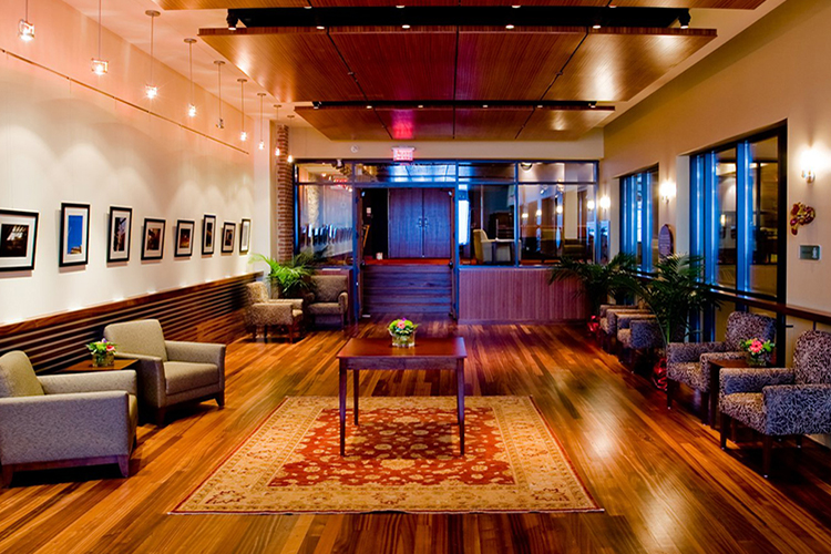 Soft chairs, rugs and artwork in the lobby of the Grand Theatre in Kingston.