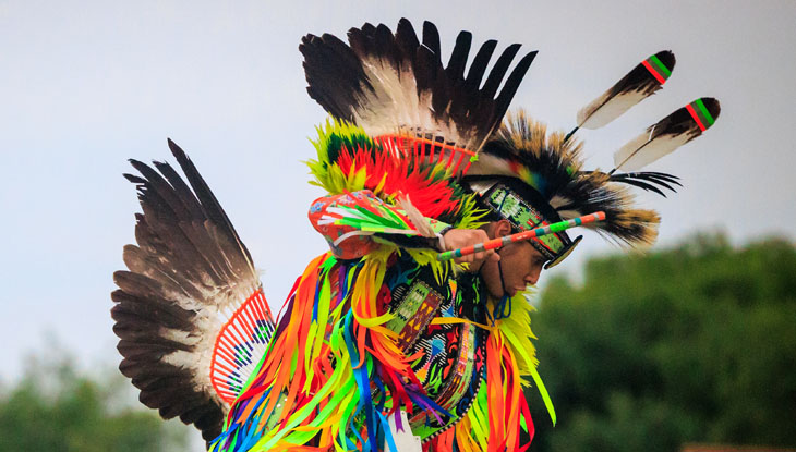 A man performs at a competition pow wow during Summer Solstice Festival at Mādahòkì Farm.