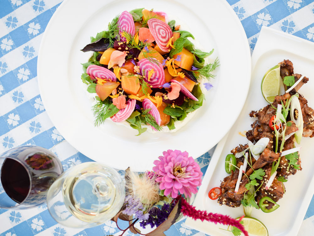 Two colourful plates of food and glasses of wine at Oxley Estate Winery.