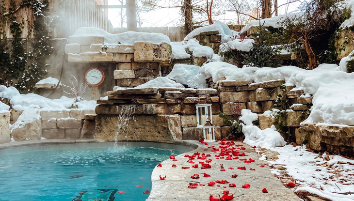 Rose petals scattered next to a pool of water