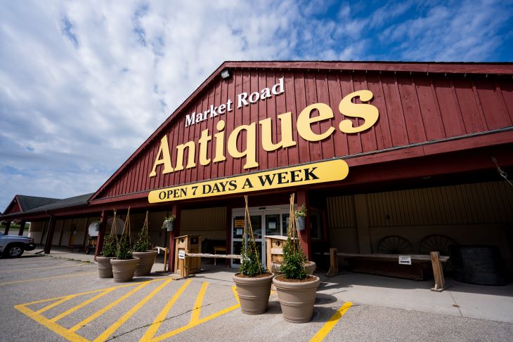 The storefront of Market Road Antiques in daylight. 