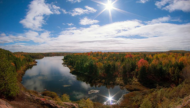 Rivière coulant le long d’une forêt aux vives couleurs d’automne.