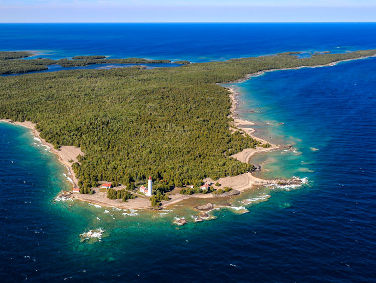 Aerial view of a shoreline with a lighthouse