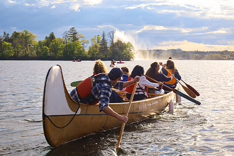  A group of people paddling in a heritage canoe.