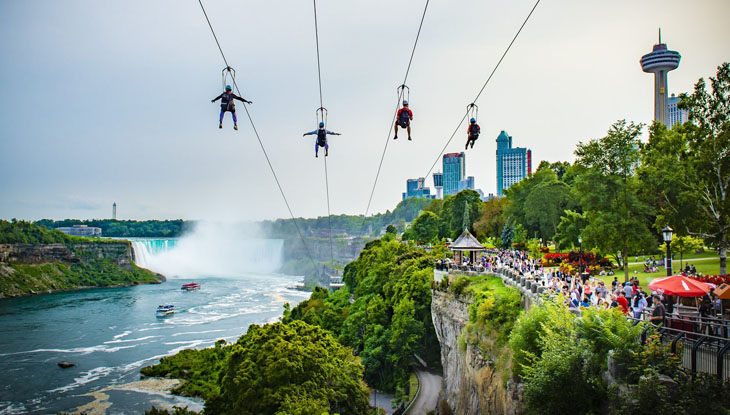 Riders zipline high above the Niagara River at the WildPlay Zipline.