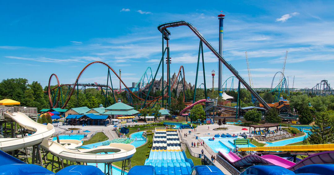 An amusement park filled with water slides, roller coasters and free fall rides.